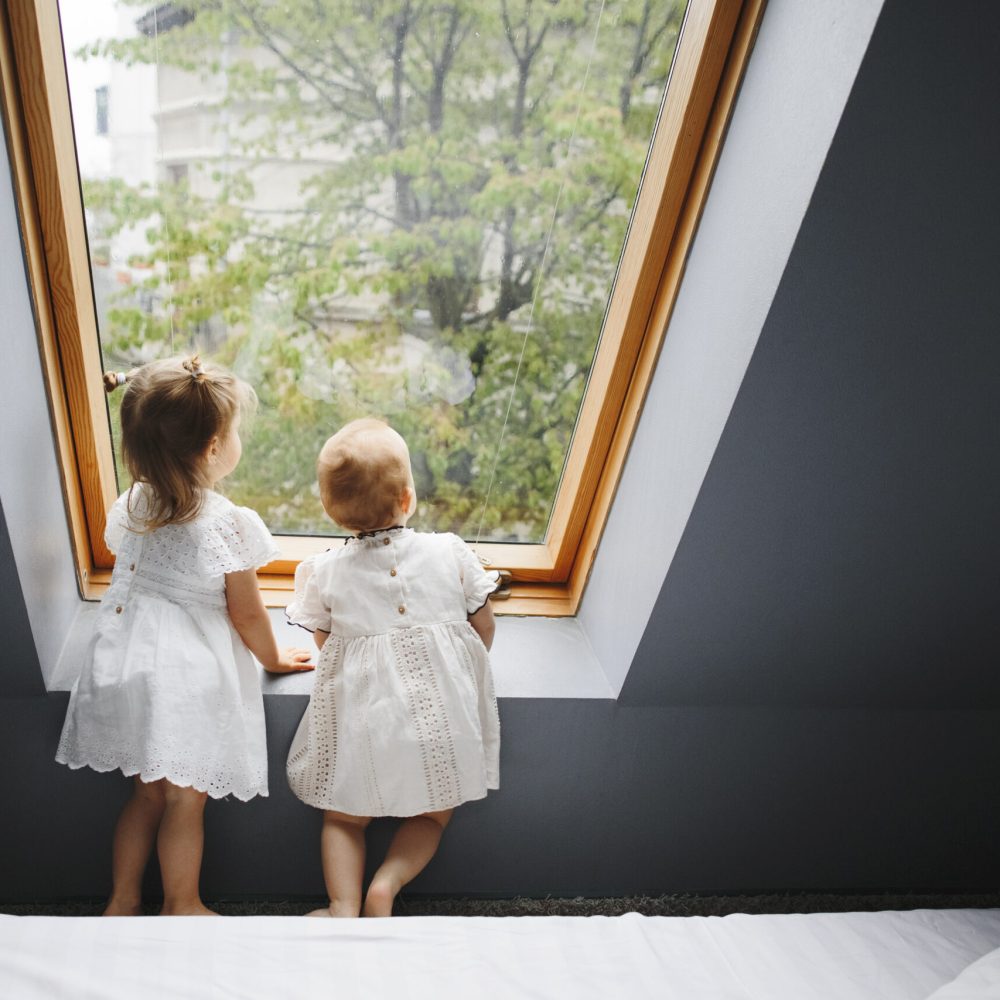 Two happy girls are looking at something in the window Two happy girls are looking at something in the window