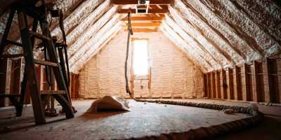 An inside view of an attic covered with spray foam
