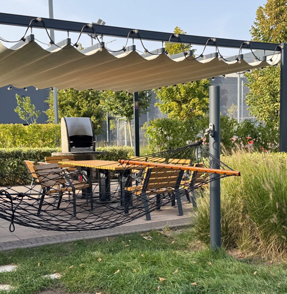 Hammock on green grass with black metal holder in a sunny day – daylight shoot Hammock on green grass with black metal holder in a sunny day - daylight shoot . High quality photo